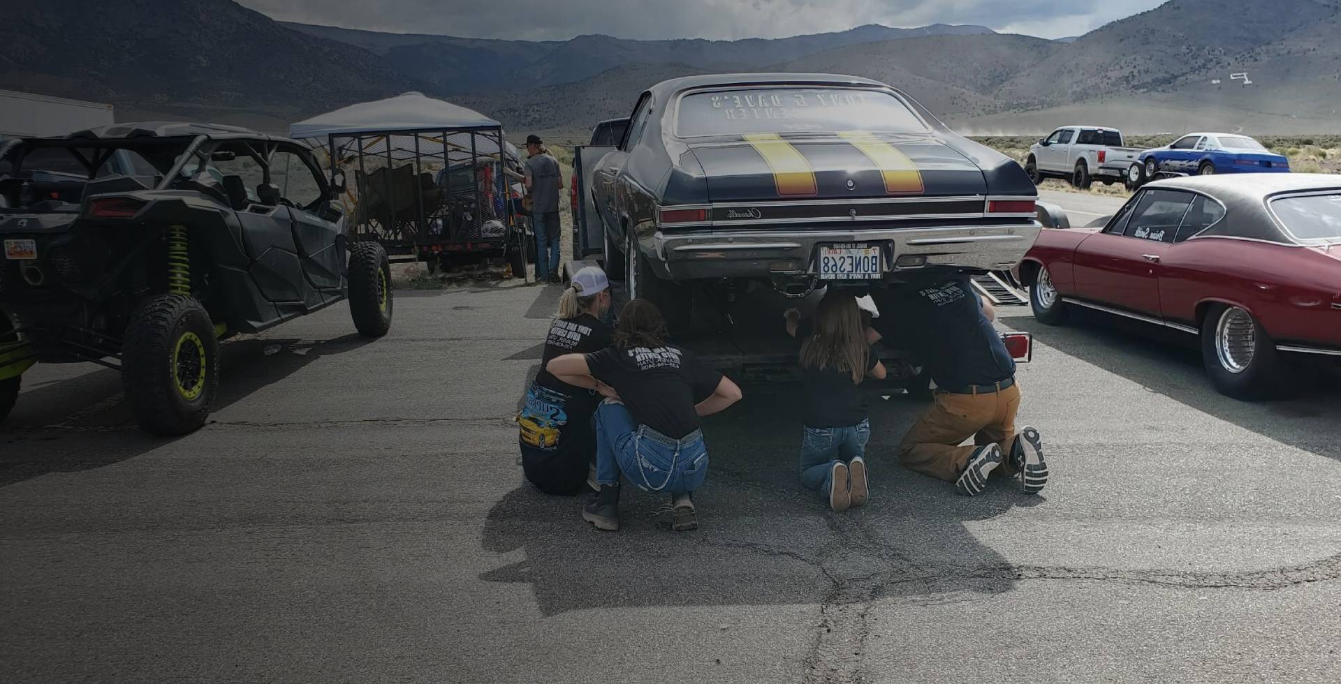 Four professional are checking the car for repairing 